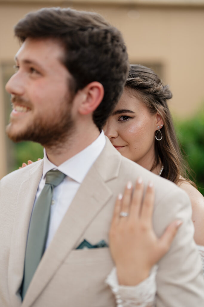 Bride holding her groom while intimately looking at Atlanta photo and video team