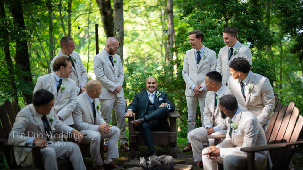 Groomsmen by fireplace near groom’s suite at Nantahala Wedding Venue North Carolina
