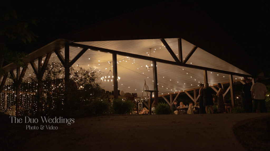 Evening reception under pavilion with string lights at Nantahala Wedding Venue North Carolina
