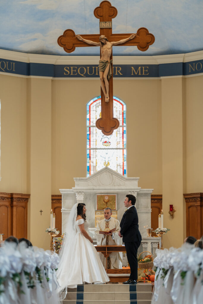 Bride and Groom standing at the ceremony alter at St.Benedict Catholic Church in John's Creek, Georgia