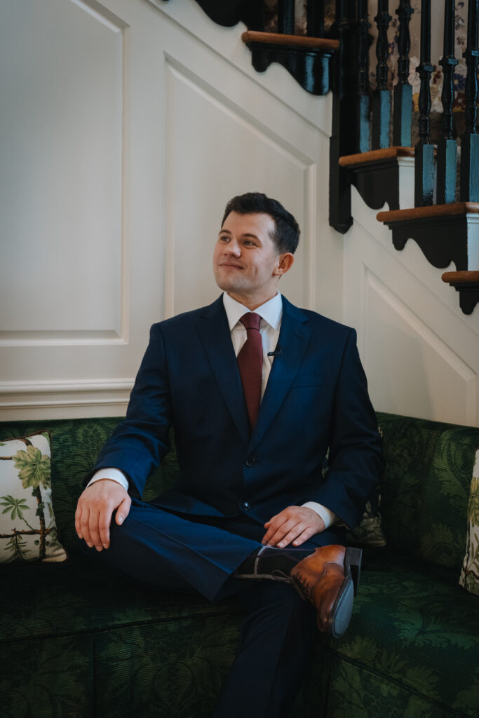 Groom showing off his suit and at the Meadowlands at the Darien Community Association. in Darien Connecticut.