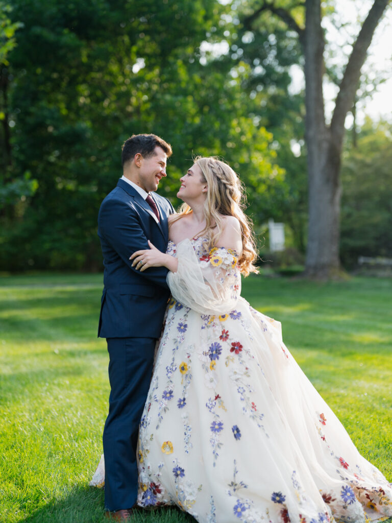 Bride and Groom smiling at each other at the Meadowlands at the Darien Community Association. in Darien Connecticut.