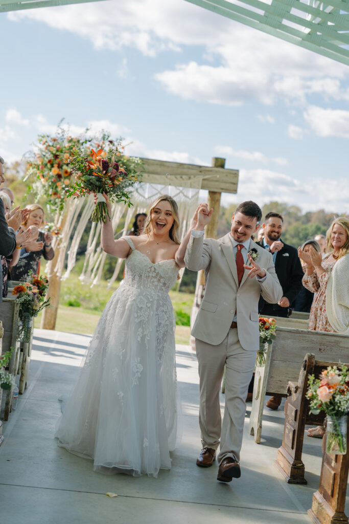 bride and groom walking down isle at west milford farm in cumming georgia