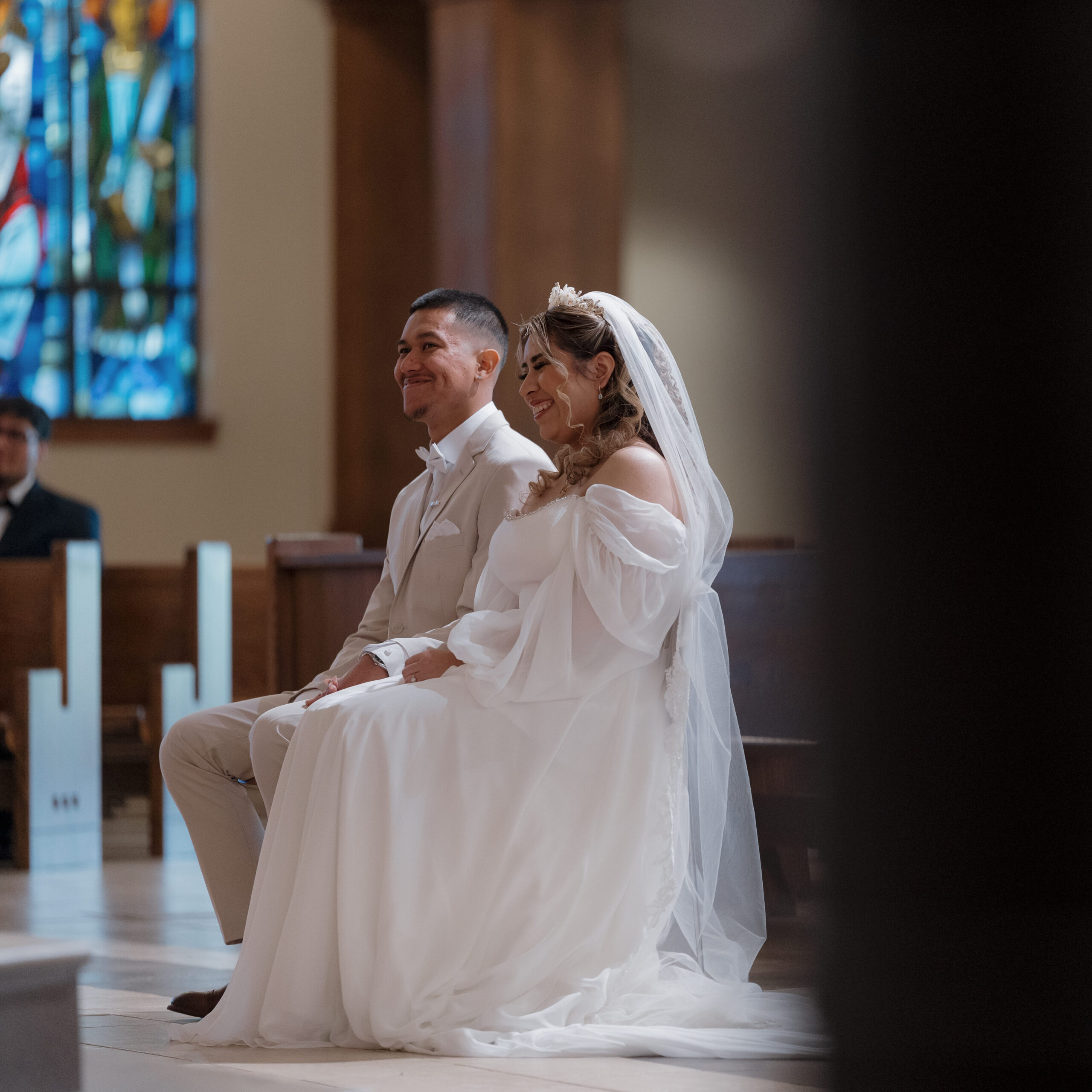 Bride and Groom sitting at the alter of their Wedding at the Immaculate Heart of Mary Catholic Church, in Atlanta