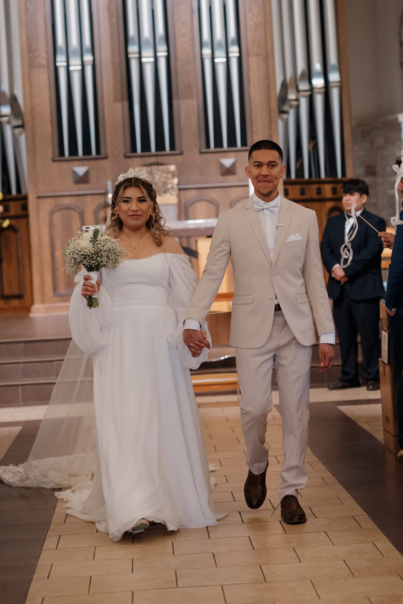 Bride and Groom, walking down aisle, of their wedding at the Immaculate Heart of Mary Catholic Church, in Atlanta.