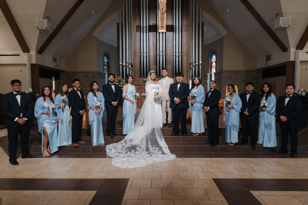 Wedding party standing in front of the alter the Immaculate Heart of Mary Catholic Church, in Atlanta.