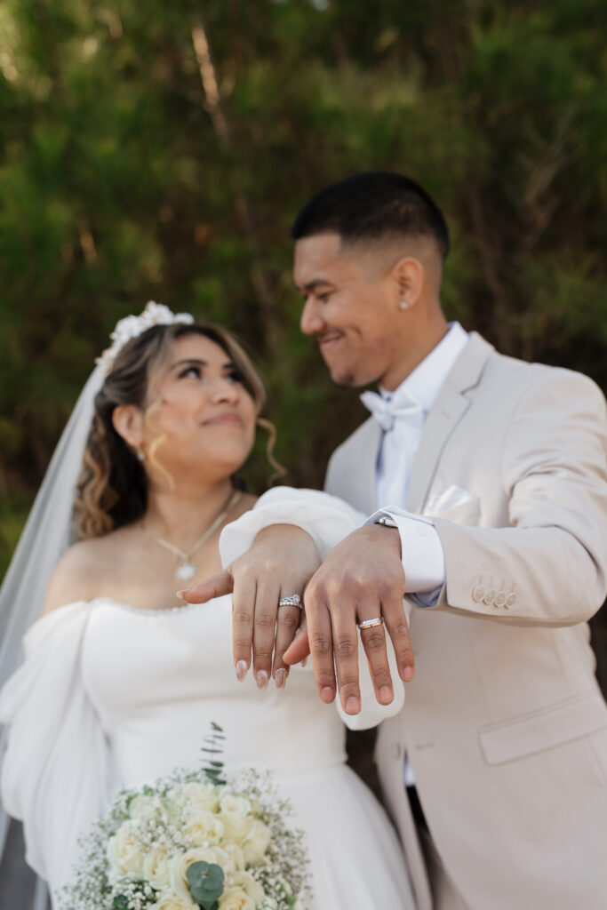 Wedding photo of bride and groom showing their rings at Mystic Acres wedding venue in Griffin, GA.