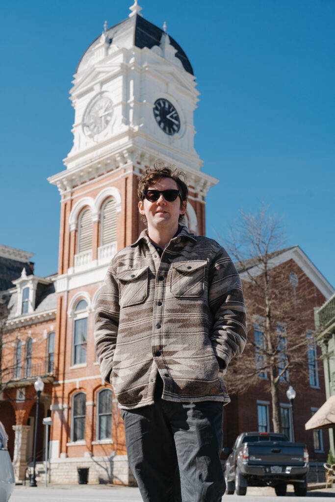 Photographer posing in front of the Covington Square clocktower in downtown Covington, GA