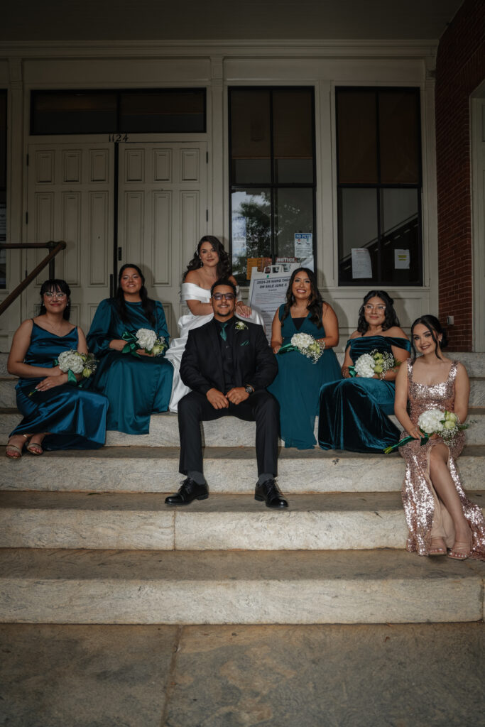 Wedding party portraits on the steps of the clocktower in Covington, GA