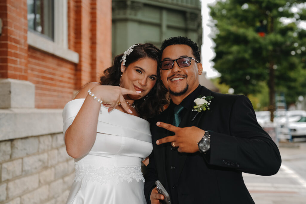 Bride and Groom poses for Wedding Photographer in Covington Square in Covington, GA