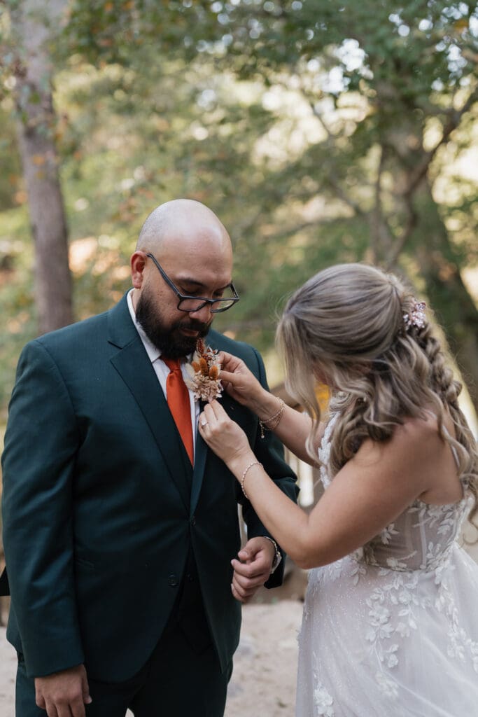 Bride fixing Groom's suit at Vecoma at the yellow river, in Snellville Georgia.