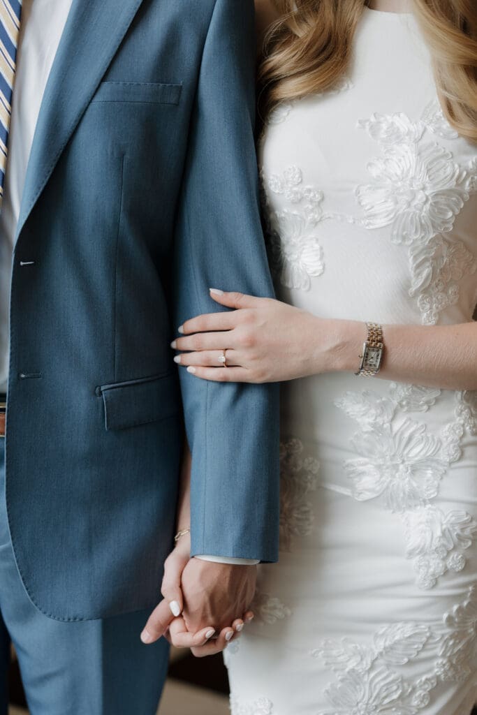 engaged woman holding her fiance's arm