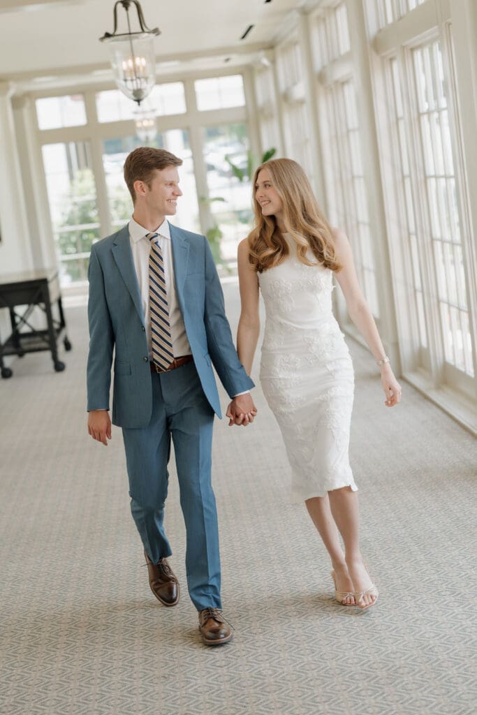 engaged couple walking in tpc sugarloaf's hallway